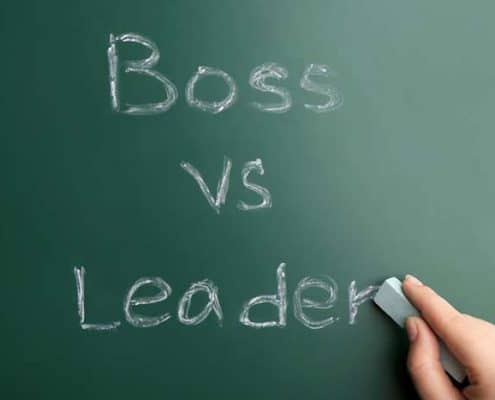 Boss vs Leader written on a chalk board