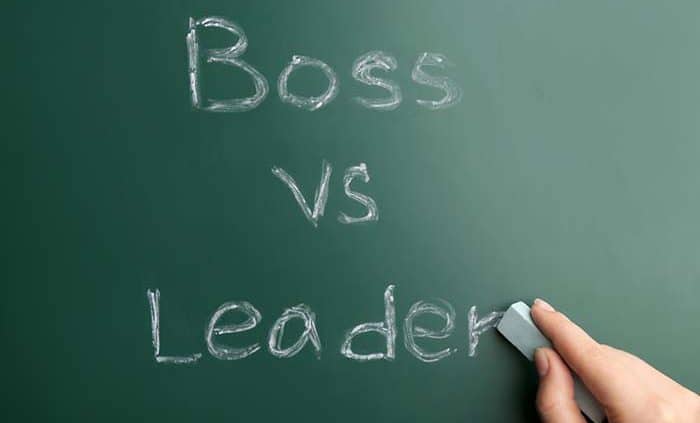 Boss vs Leader written on a chalk board
