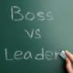 Boss vs Leader written on a chalk board