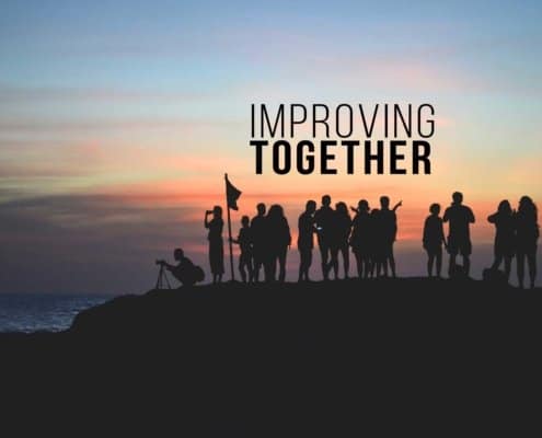 People standing as a group watching sunset