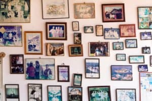 Frames of family pictures hanging on a wall of a house