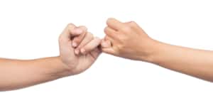 2 people making a pinky promise