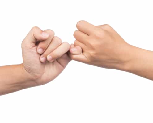 2 people making a pinky promise