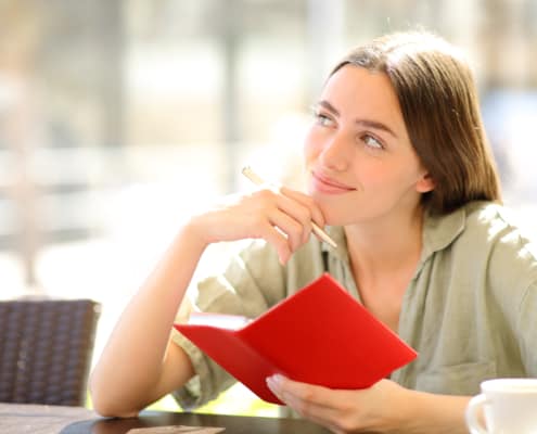 Girl readying from a red book